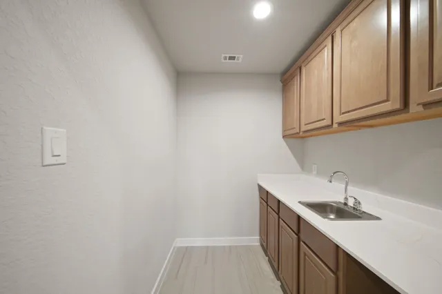 a kitchen with a sink and cabinets
