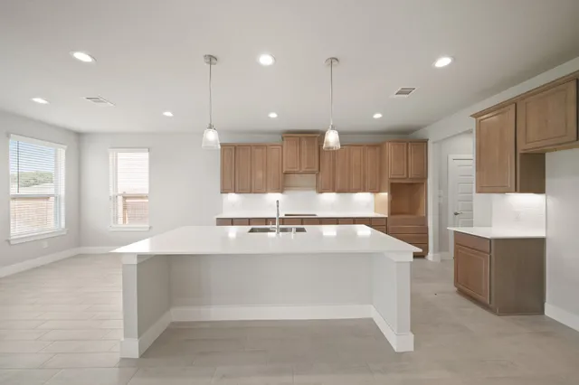 a large white kitchen with a large window