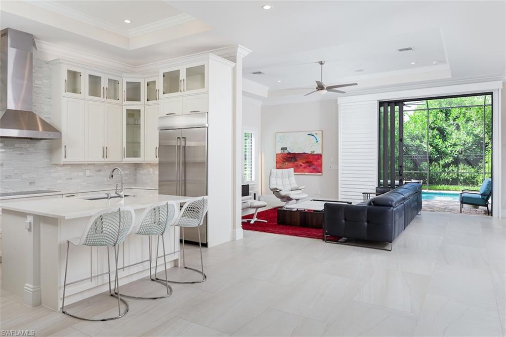 2879 Coco Lakes Drive Naples, FL 34105 - Photo 1 of 30 a living room with furniture and flat screen tv