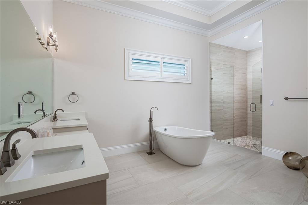 2879 Coco Lakes Drive Naples, FL 34105 - Photo 12 of 30 a bathroom with a sink and a bathtub