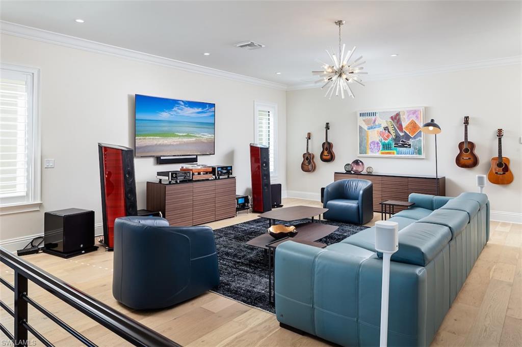2879 Coco Lakes Drive Naples, FL 34105 - Photo 15 of 30 a living room with furniture and a flat screen tv