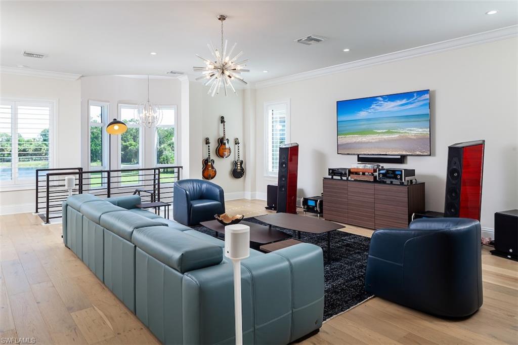 2879 Coco Lakes Drive Naples, FL 34105 - Photo 16 of 30 a living room with furniture and a flat screen tv