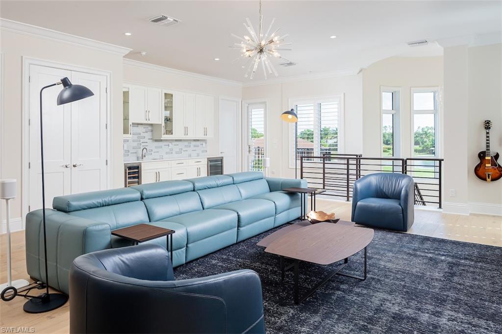 2879 Coco Lakes Drive Naples, FL 34105 - Photo 17 of 30 a living room with furniture a rug and a chandelier