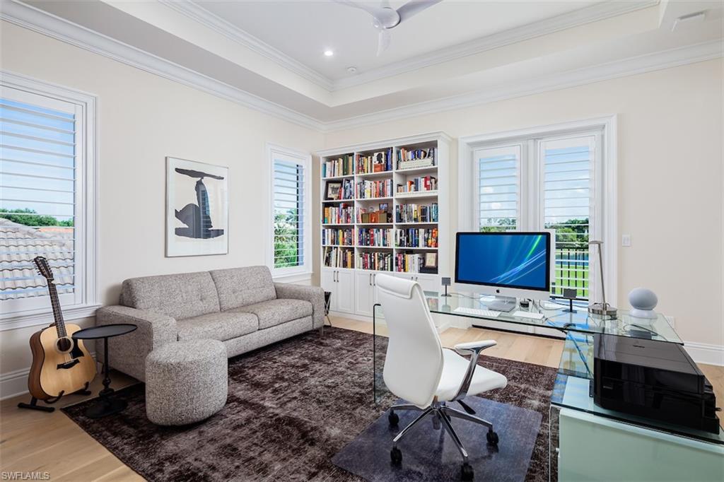 2879 Coco Lakes Drive Naples, FL 34105 - Photo 18 of 30 a living room with furniture and a flat screen tv