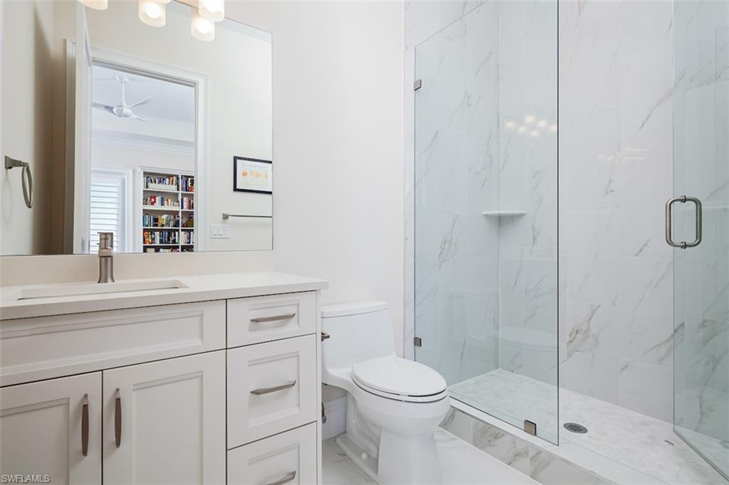 2879 Coco Lakes Drive Naples, FL 34105 - Photo 20 of 30 a bathroom with a sink a toilet and shower