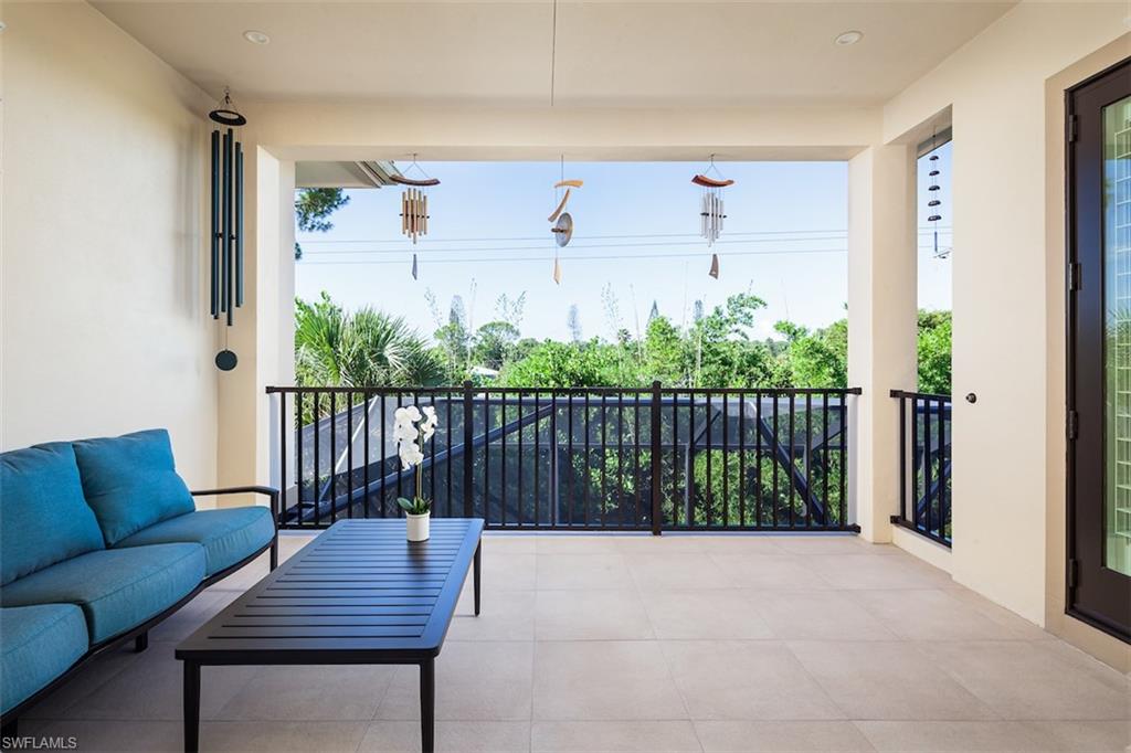 2879 Coco Lakes Drive Naples, FL 34105 - Photo 22 of 30 a balcony view with a potted plant and wooden fence