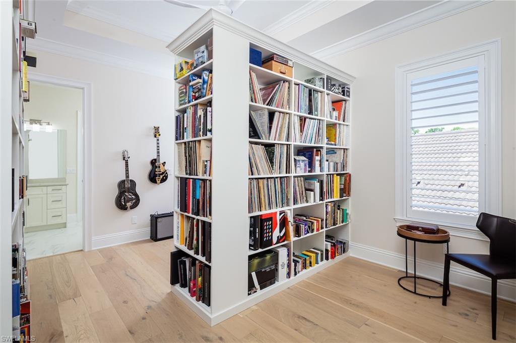 2879 Coco Lakes Drive Naples, FL 34105 - Photo 26 of 30 a room with furniture and a book shelf