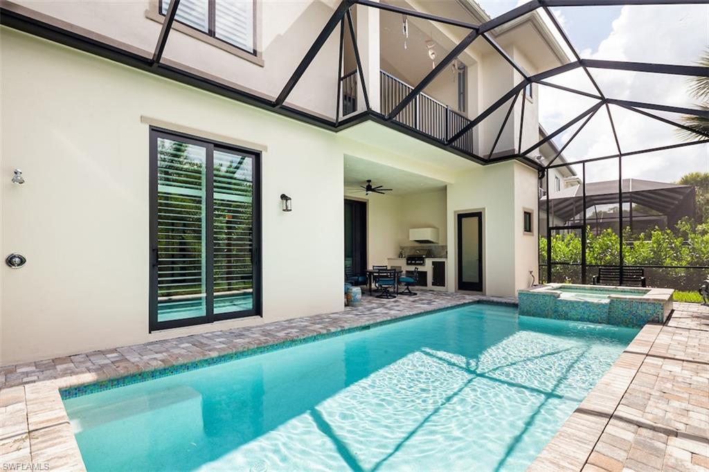 2879 Coco Lakes Drive Naples, FL 34105 - Photo 10 of 30 a front view of a house with a yard table and chairs