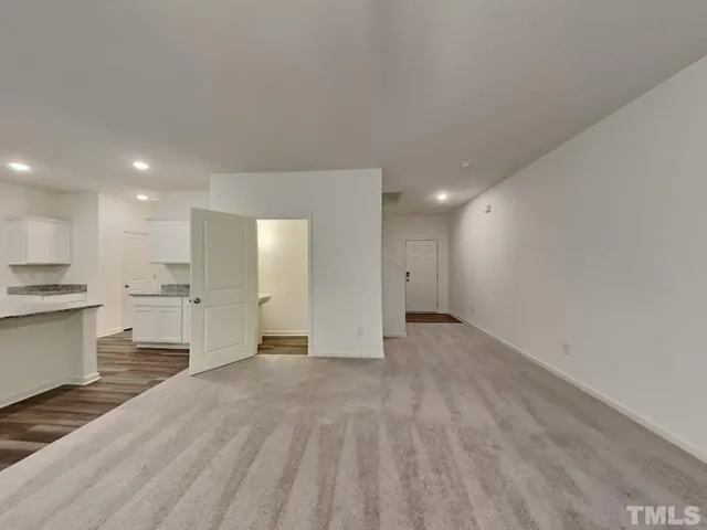 a view of a kitchen with a sink and a refrigerator