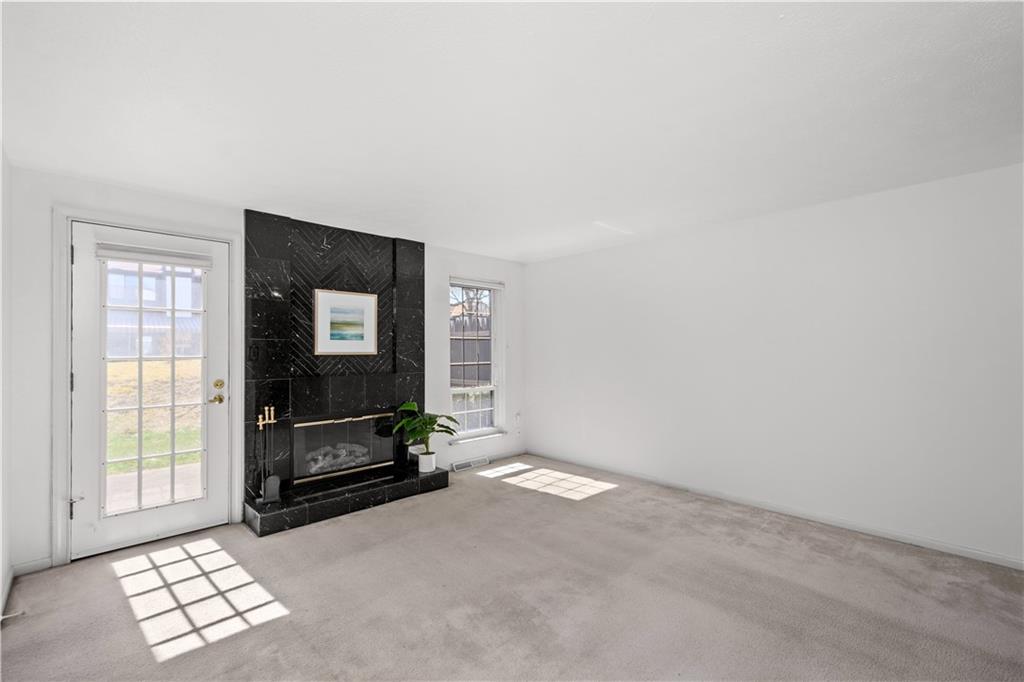 204 Timber Lane Sewickley, PA 15143 - Photo 11 of 25 a living room with furniture a flat screen tv and a window