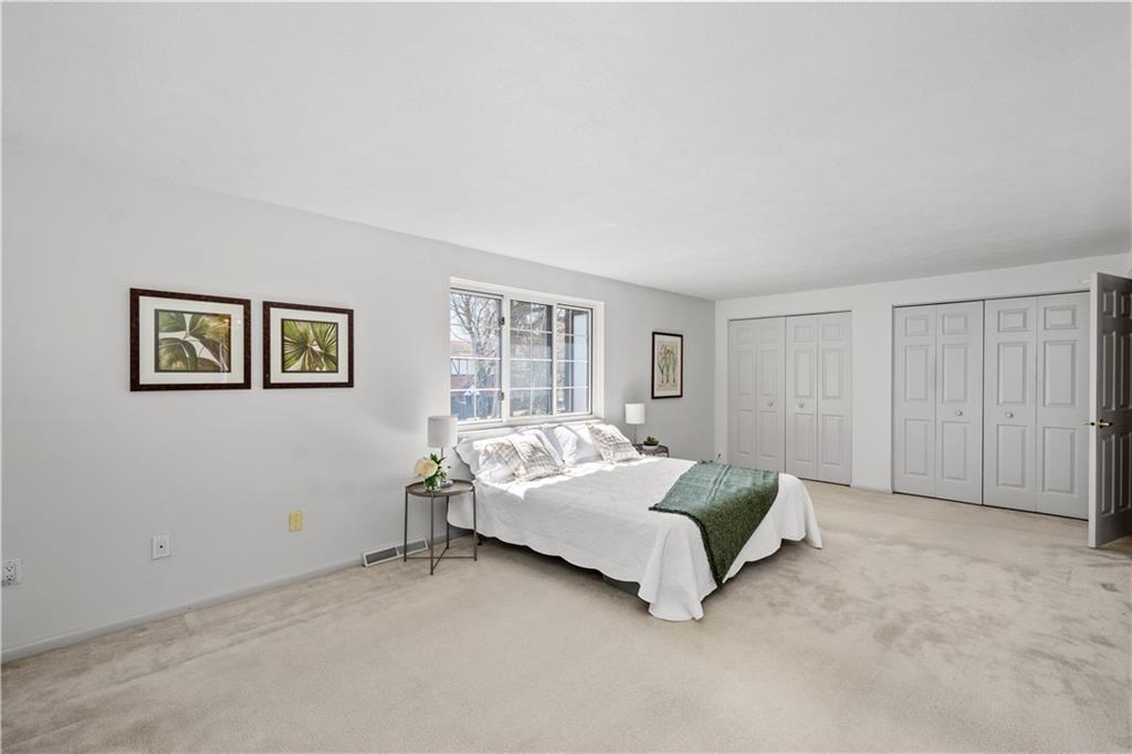 204 Timber Lane Sewickley, PA 15143 - Photo 18 of 25 a bed sitting in a spacious bedroom next to a window and a lamp