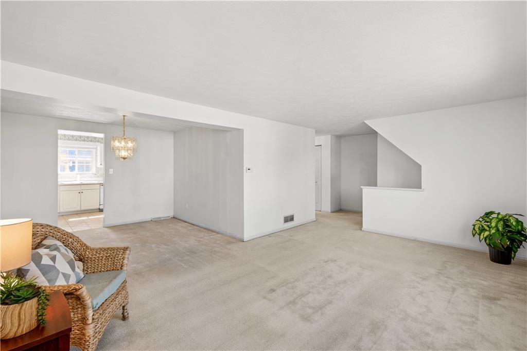 204 Timber Lane Sewickley, PA 15143 - Photo 3 of 25 an empty room with potted plants and wooden floor