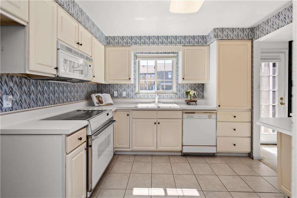 204 Timber Lane Sewickley, PA 15143 - Photo 7 of 25 a kitchen with a sink stove and cabinets