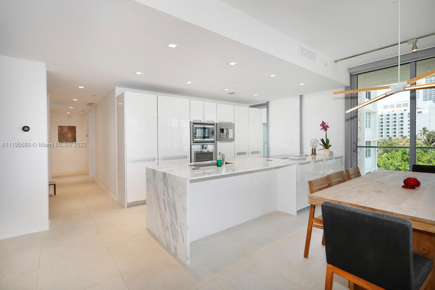 Miami Beach Miami Beach, FL 33139 - Photo 14 of 27 a kitchen with stainless steel appliances kitchen island granite countertop a refrigerator and a sink