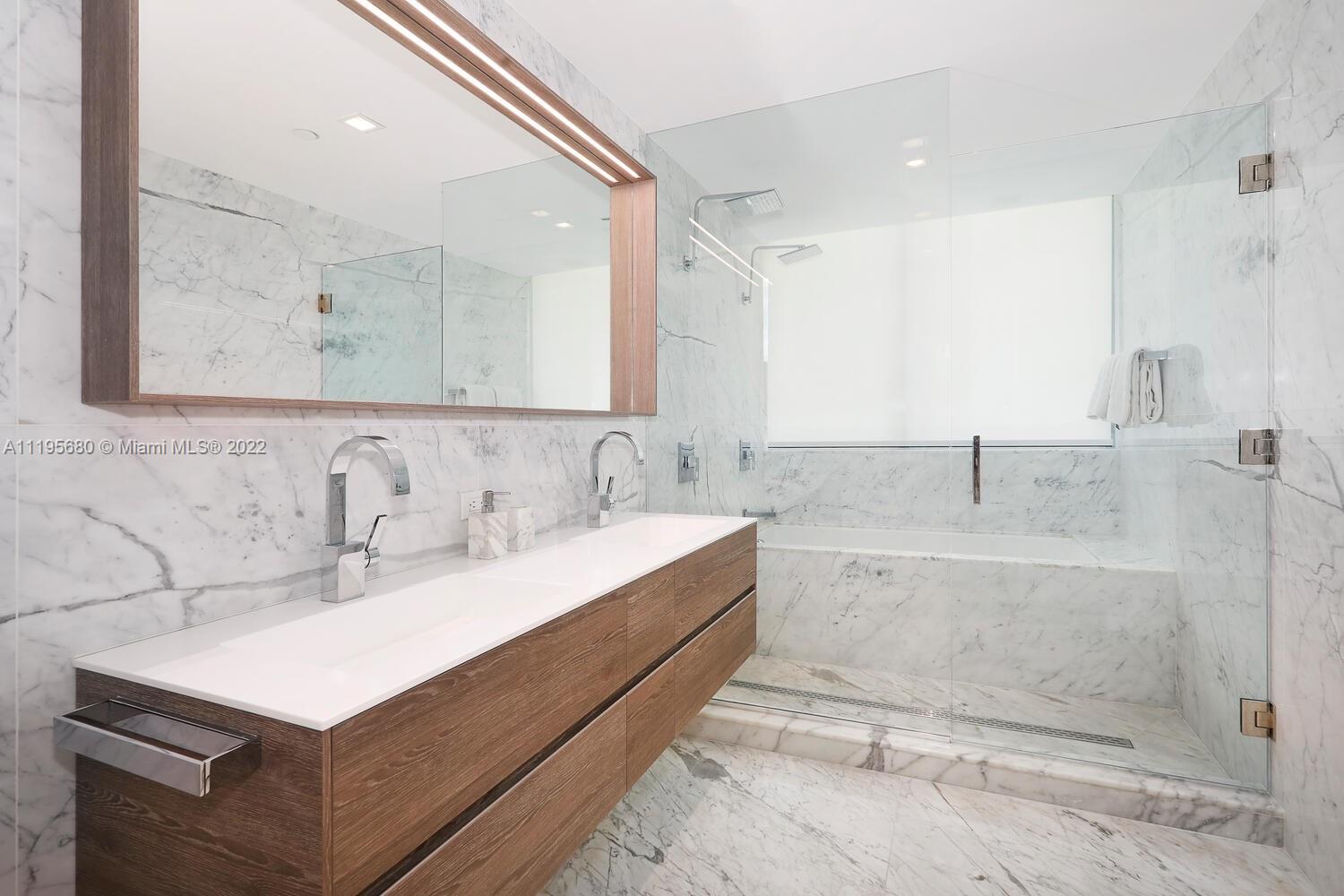 Miami Beach Miami Beach, FL 33139 - Photo 17 of 27 a bathroom with a sink mirror and a shower