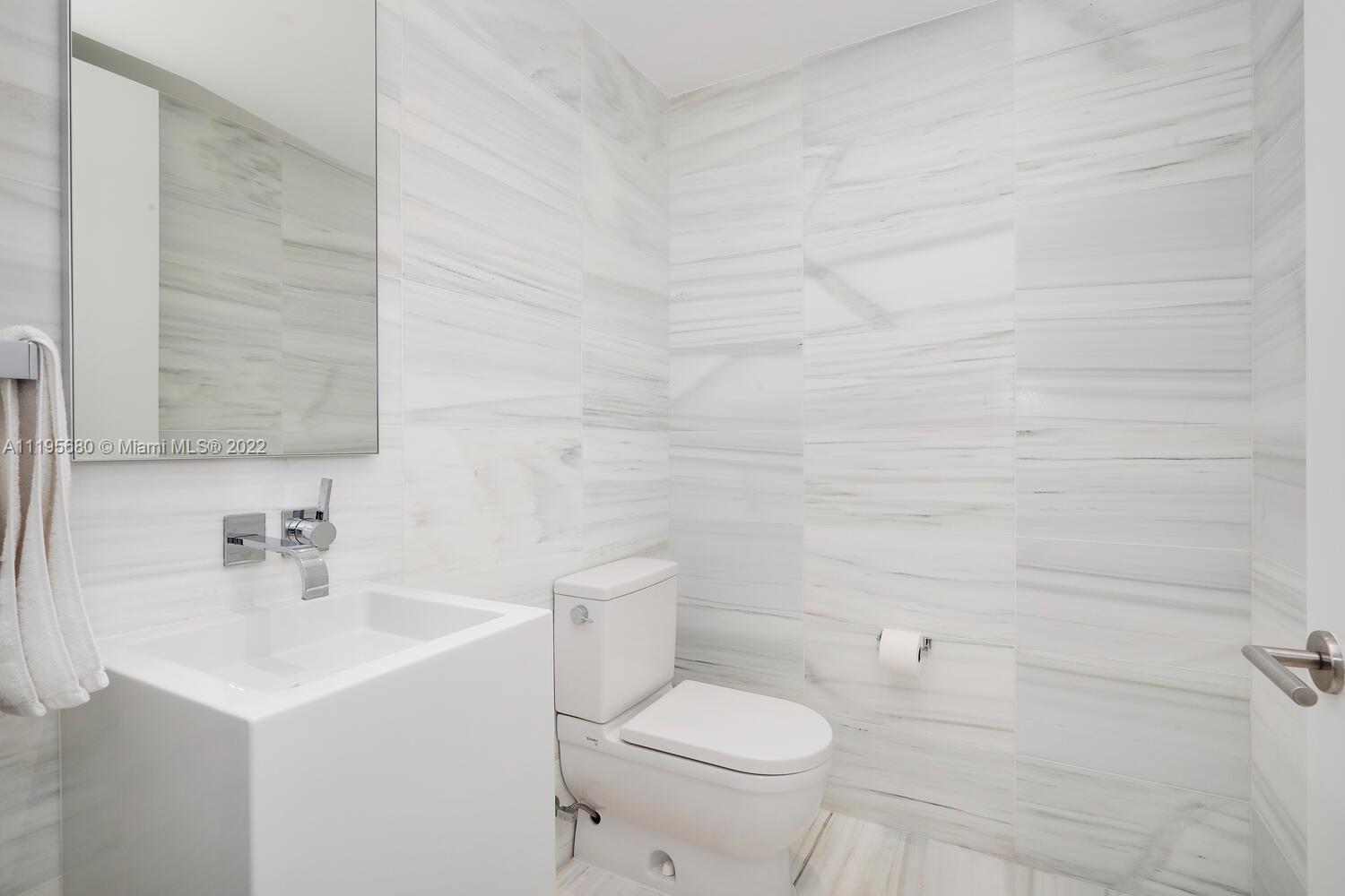 Miami Beach Miami Beach, FL 33139 - Photo 22 of 27 a bathroom with a sink a toilet and mirror