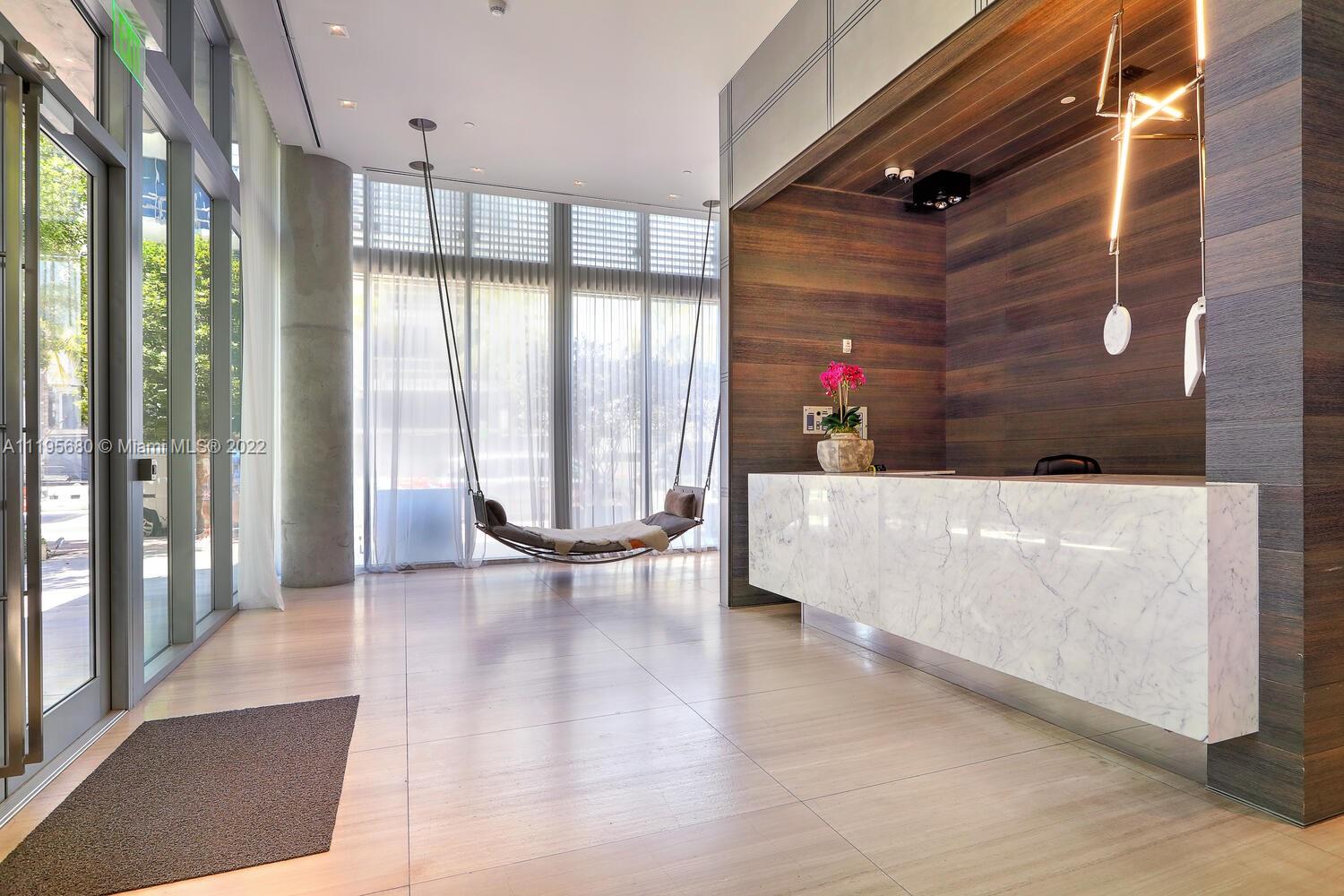 Miami Beach Miami Beach, FL 33139 - Photo 25 of 27 a view of an empty room with wooden floor and a glass door