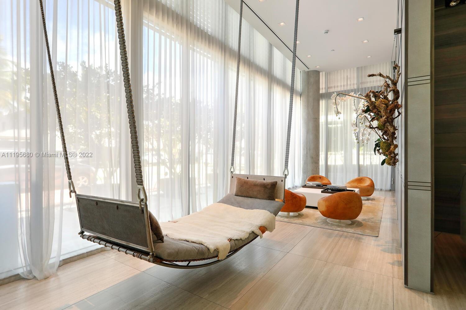 Miami Beach Miami Beach, FL 33139 - Photo 26 of 27 a bedroom with a bed and large windows