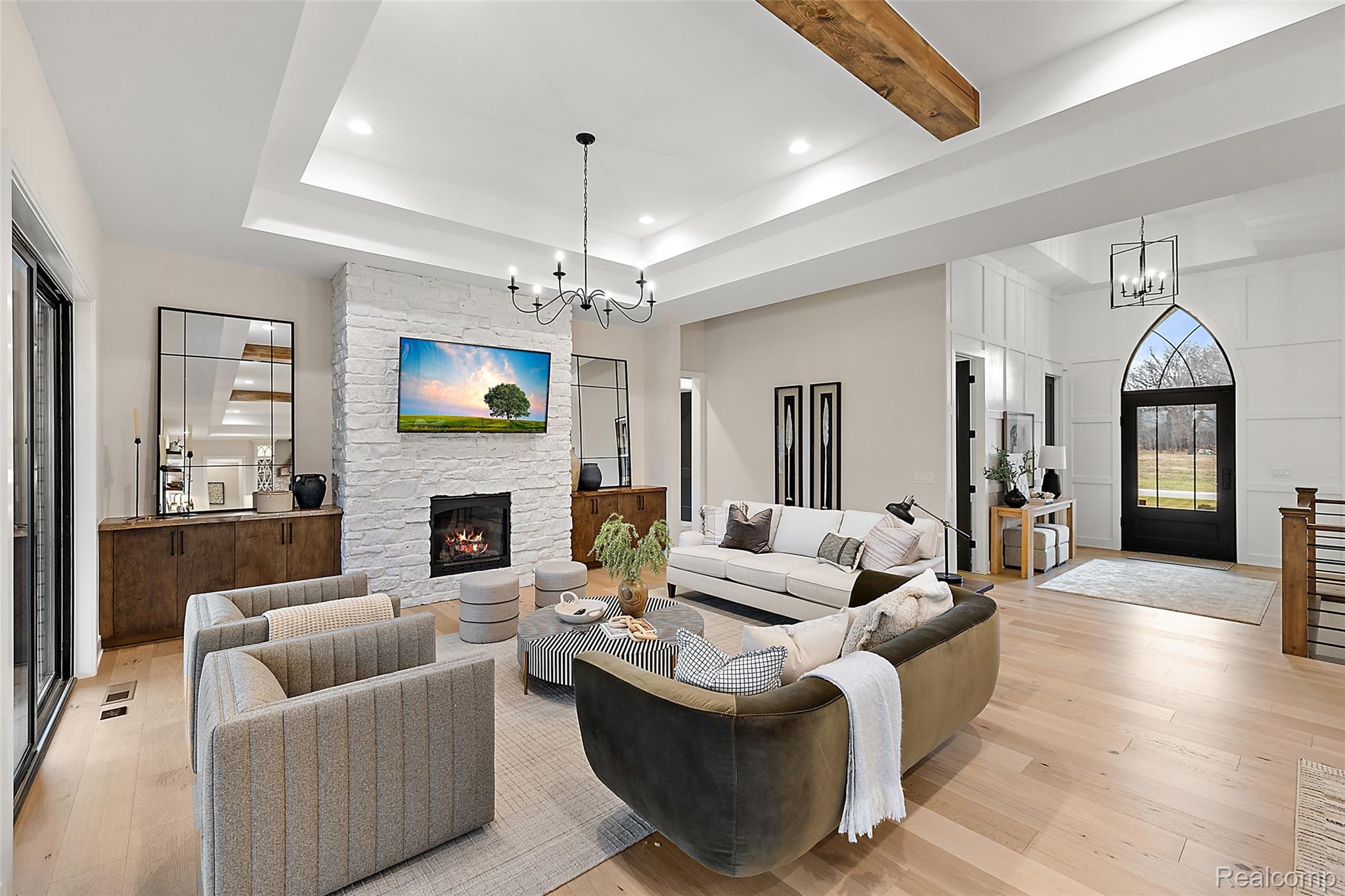 70413 Renata Court Romeo, MI 48065 - Photo 21 of 53 Open-concept living area featuring a coffered ceiling with recessed lighting, exposed wood beam accents, and wide-plank wood-finish flooring throughout