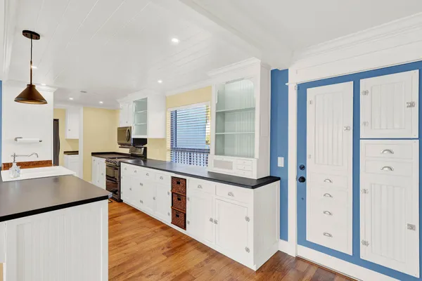 a view of a livingroom with furniture wooden floor and chandelier
