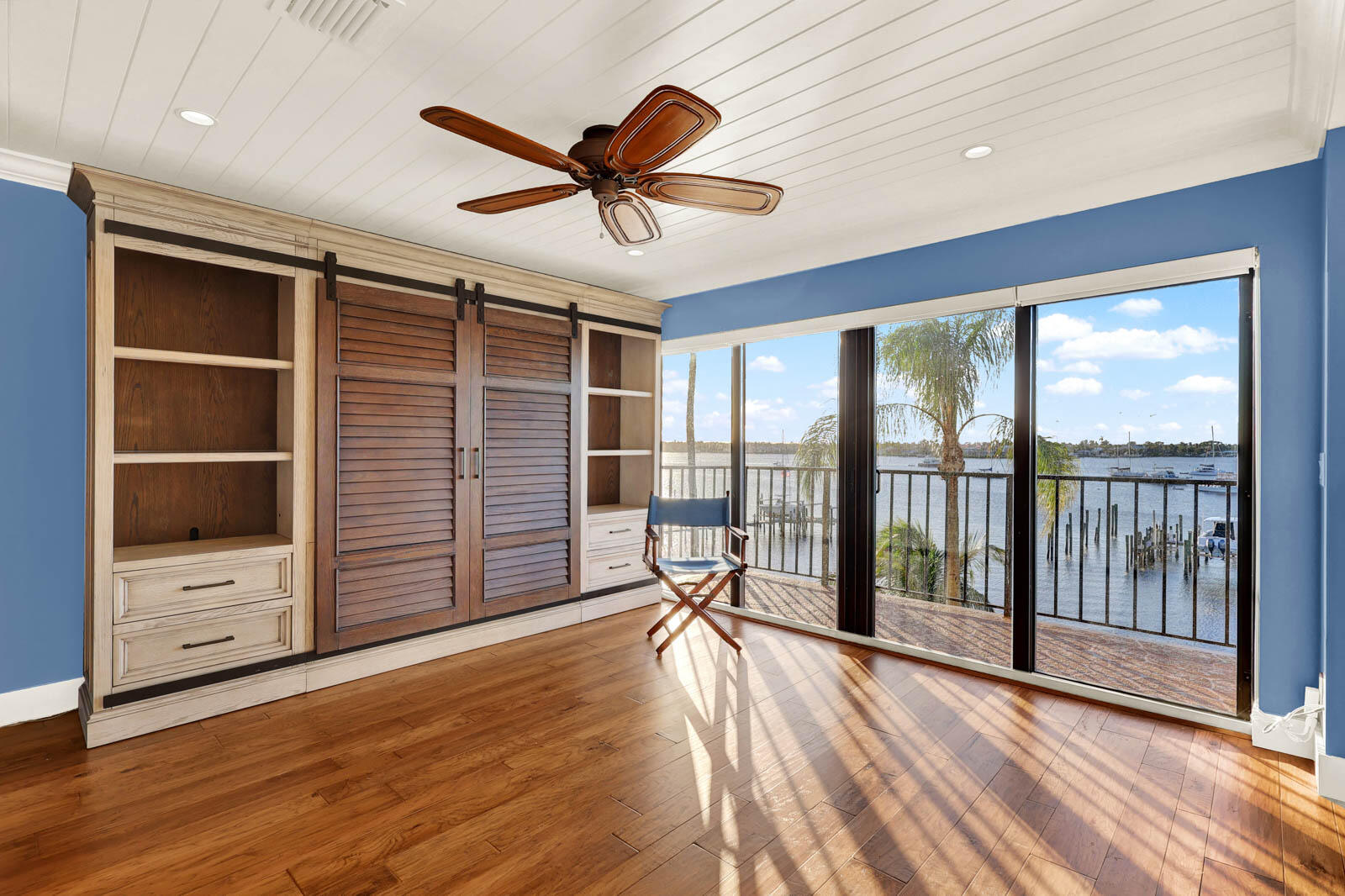 624 Southwest St Lucie Crescent, Unit 306 Stuart, FL 34994 - Photo 19 of 49 a view of a livingroom with wooden floor and a ceiling fan