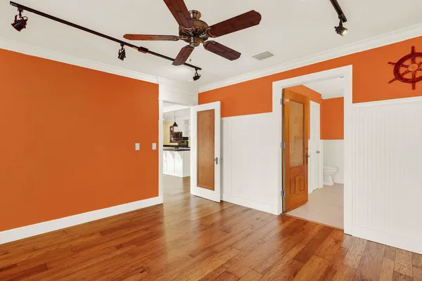 a view of an empty room with wooden floor