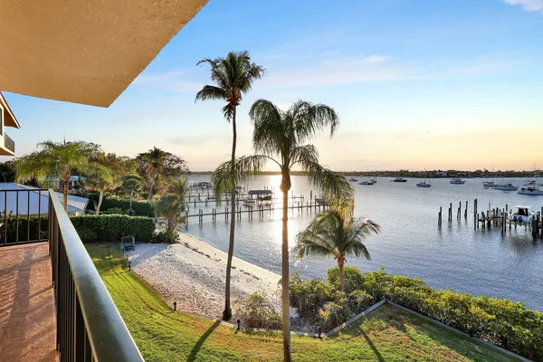 a view of a swimming pool with a patio and a yard