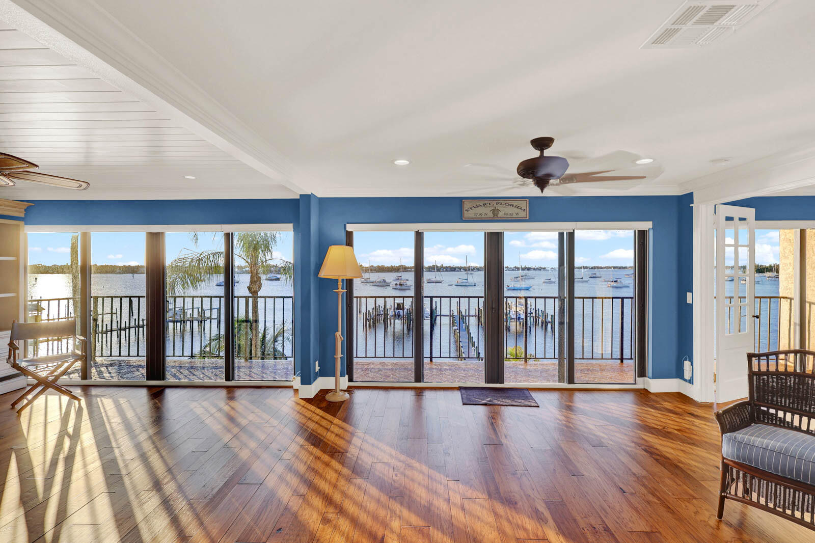 624 Southwest St Lucie Crescent, Unit 306 Stuart, FL 34994 - Photo 4 of 49 a view of an empty room with wooden floor and a window
