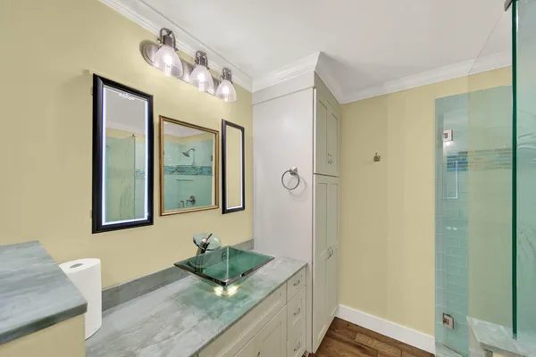 a large kitchen with stainless steel appliances a large counter top a stove a chimney a sink and a large window