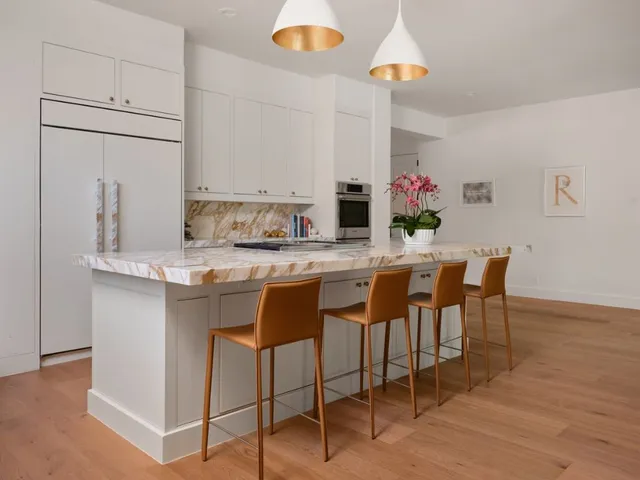 a kitchen with a dining table chairs sink and stove