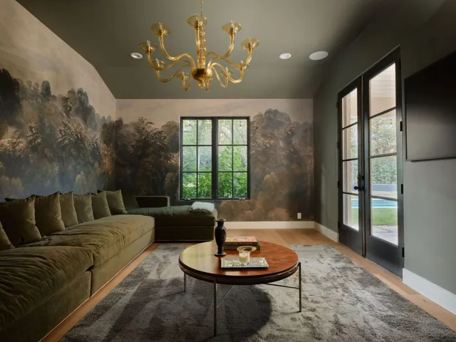 a living room with patio furniture and a large window