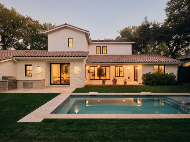 a view of a backyard with large trees