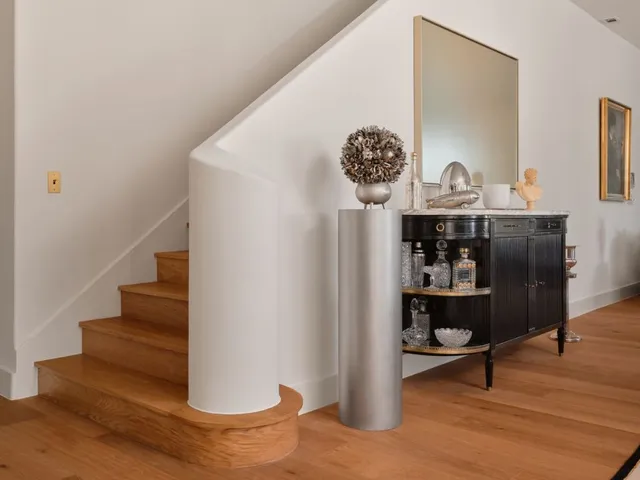 a view of entryway and hall with wooden floor