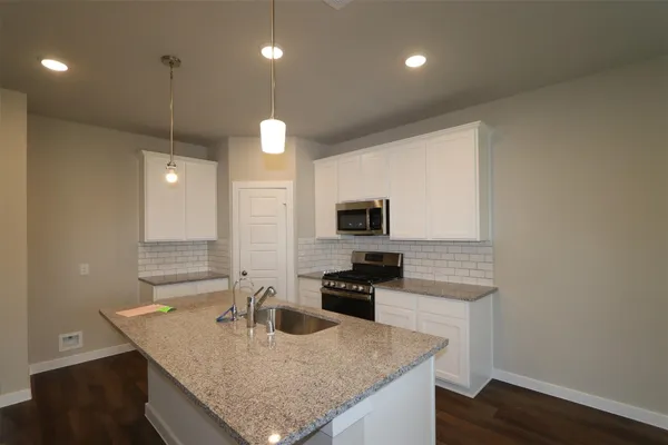 a kitchen with granite countertop counter space a sink and appliances