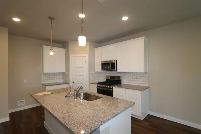 a kitchen with granite countertop counter space a sink and appliances