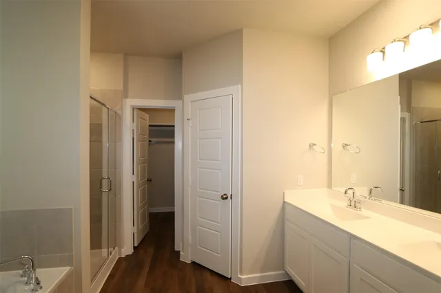 a bathroom with a double vanity sink and mirror