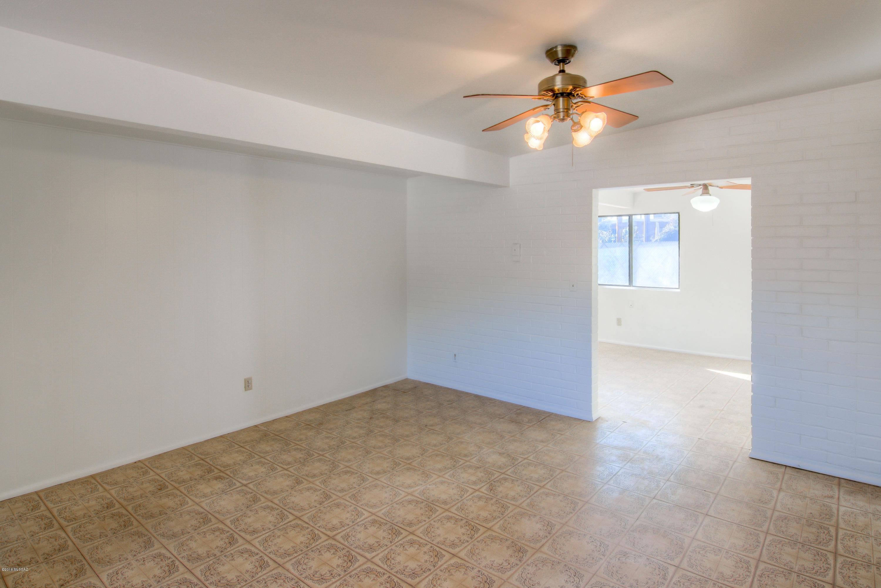 1841 West Astolat Road Tucson, AZ 85713 - Photo 22 of 40 wooden floor in an empty room with a window