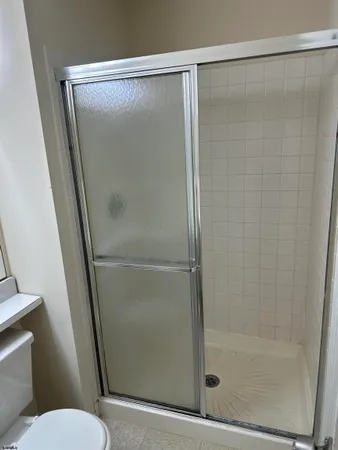 a bathroom with a glass shower door