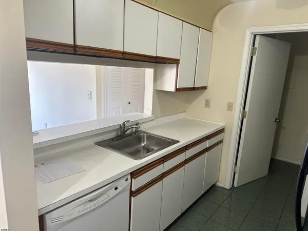 a kitchen with a sink and a refrigerator