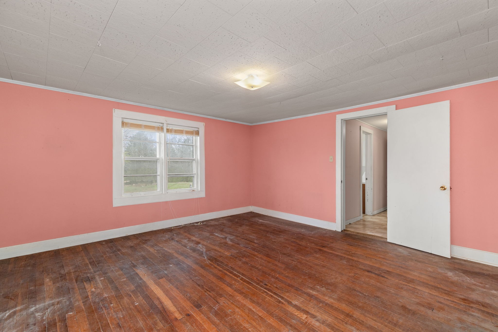 11051 Highway 64 Lexington, AL 35648 - Photo 11 of 44 an empty room with wooden floor and windows