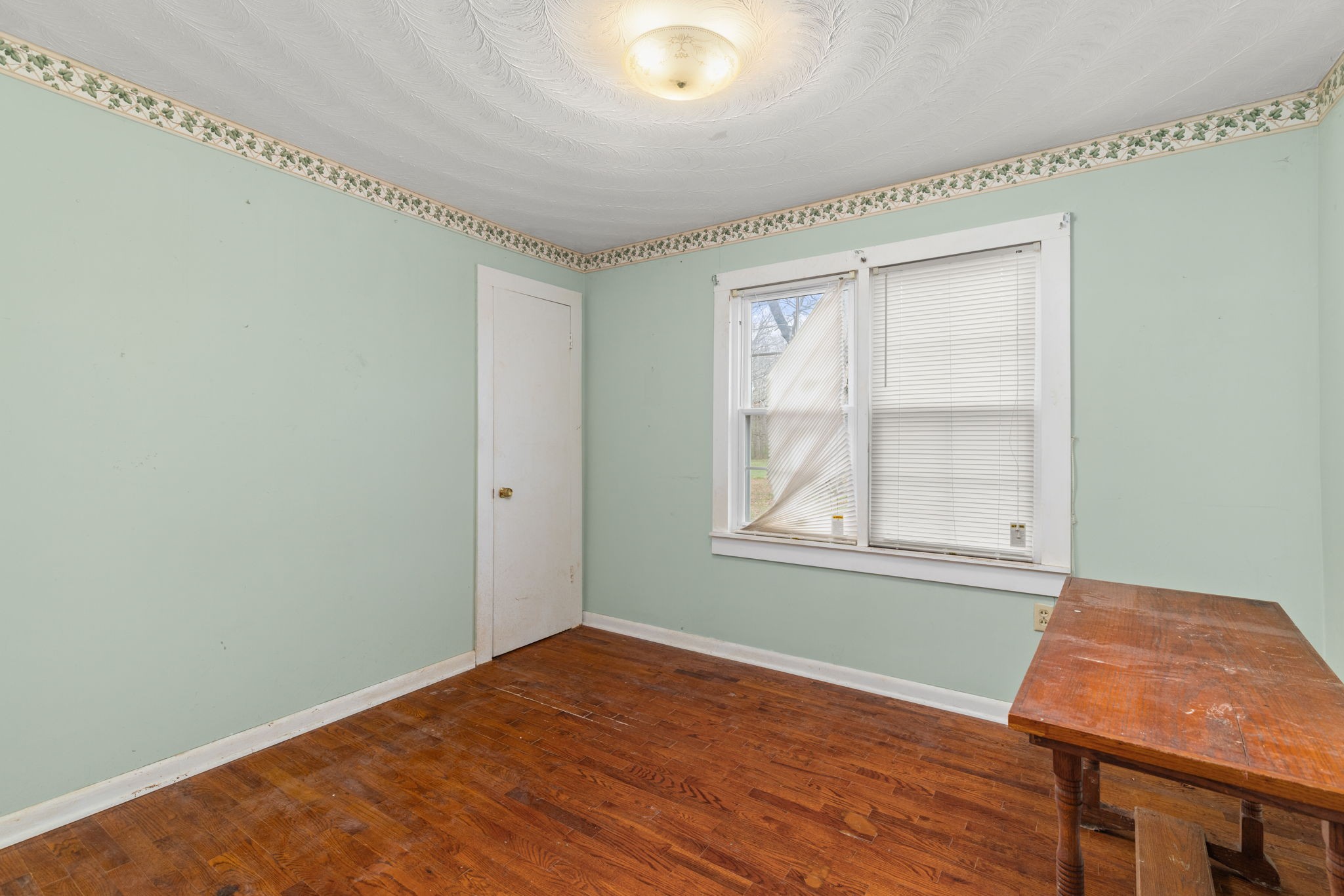 11051 Highway 64 Lexington, AL 35648 - Photo 15 of 44 an empty room with wooden floor and windows
