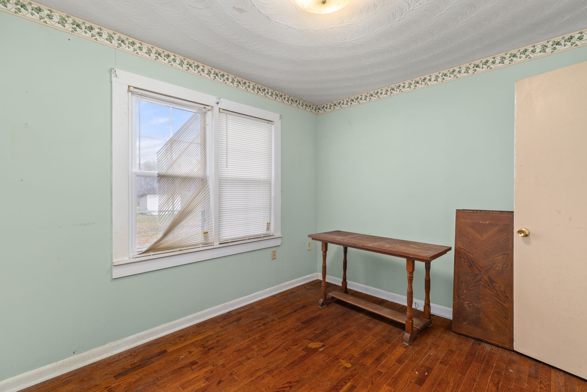 11051 Highway 64 Lexington, AL 35648 - Photo 16 of 44 a view of an empty room with wooden floor and a window