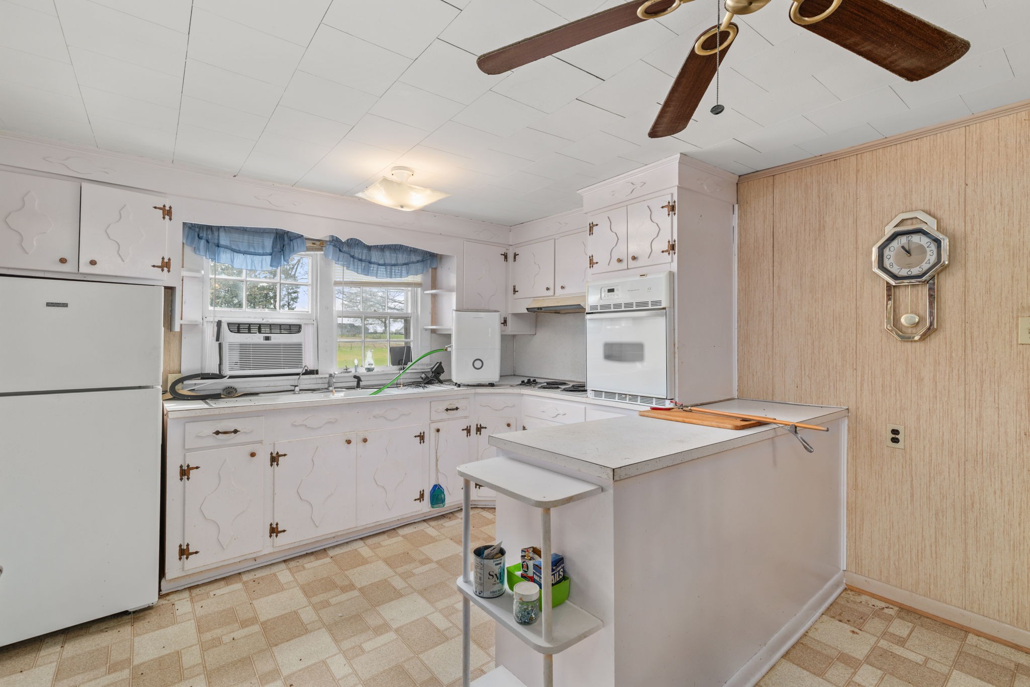 11051 Highway 64 Lexington, AL 35648 - Photo 6 of 44 a kitchen with granite countertop cabinets a stove a dining table and chairs with wooden floor
