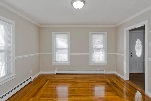a view of a room with window and wooden floor