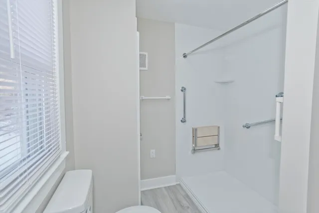 a bathroom with a shower and toilet