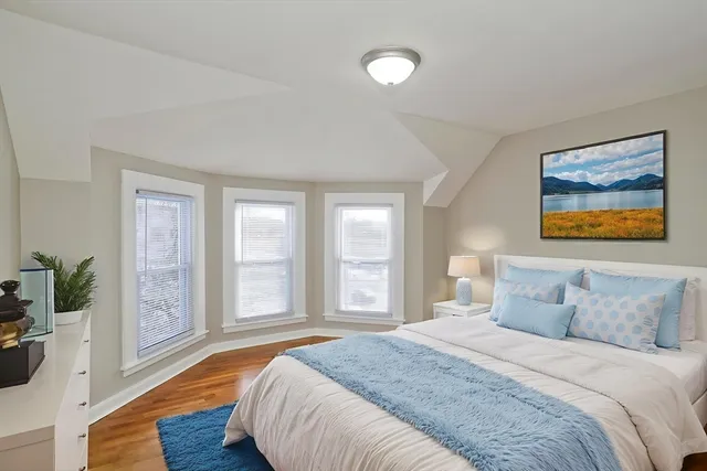 a spacious bedroom with a large bed and a large window