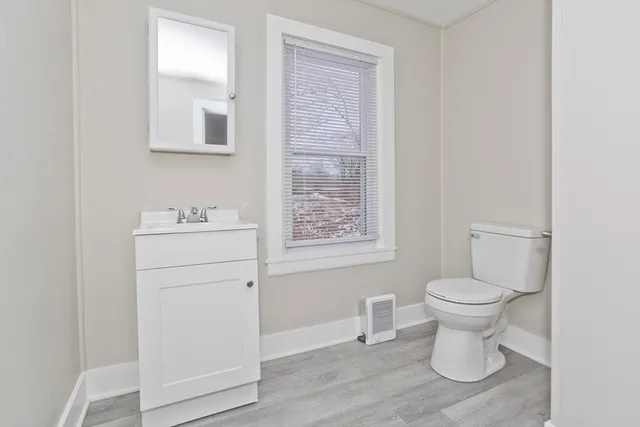 a white toilet sitting next to a bathroom sink