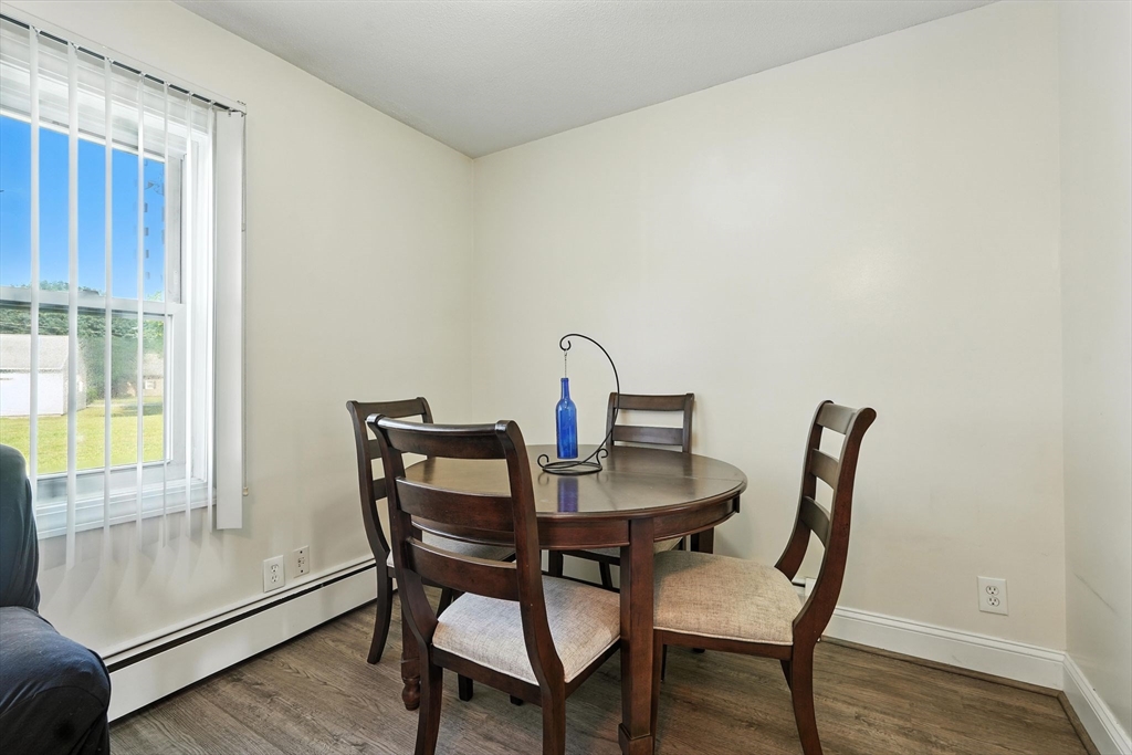 66 Applewood Drive, Unit 66 Chicopee, MA 01022 - Photo 11 of 25 a view of a dining room with furniture and wooden floor
