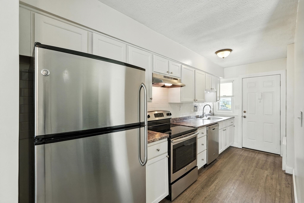 66 Applewood Drive, Unit 66 Chicopee, MA 01022 - Photo 12 of 25 a kitchen with stainless steel appliances a refrigerator a sink and white cabinets