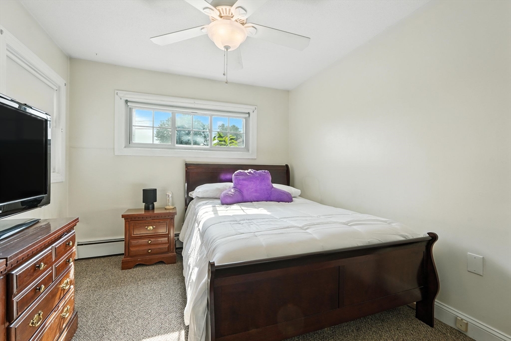 66 Applewood Drive, Unit 66 Chicopee, MA 01022 - Photo 15 of 25 a bedroom with a bed and a flat screen tv